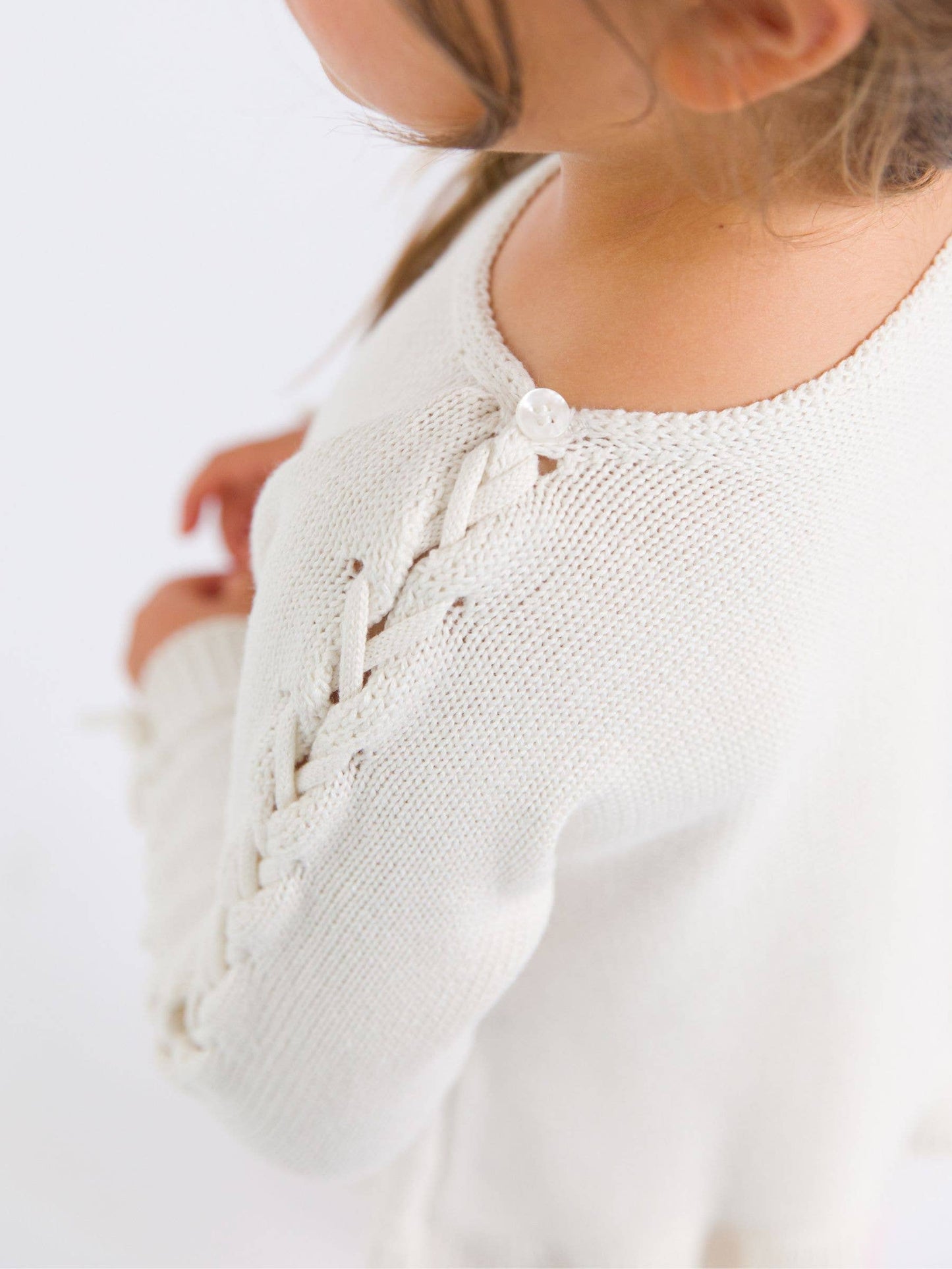 RuffleButts + RuggedButts - Girls Ivory Ruffle Hem Lace Up Sweater